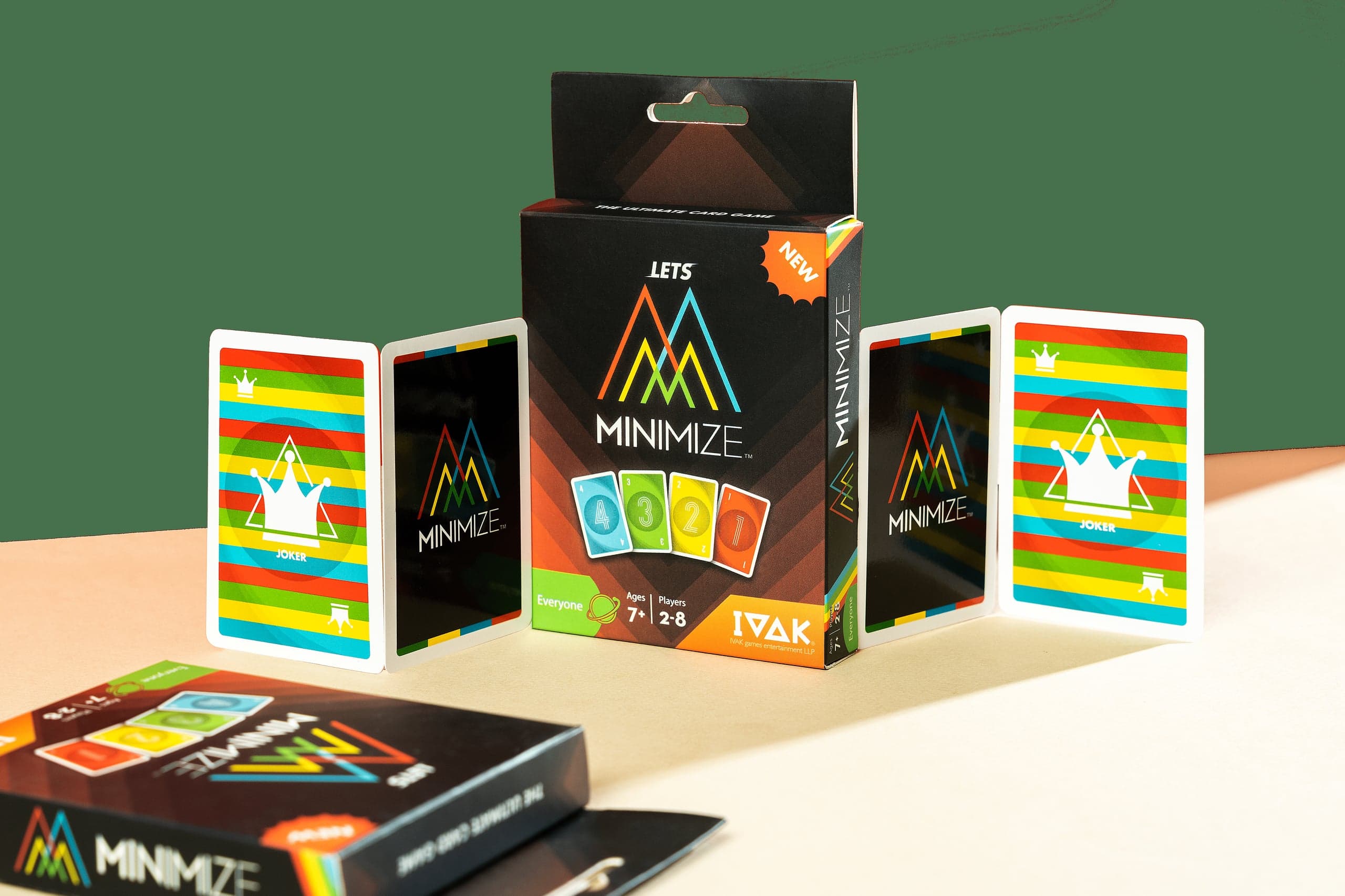 Minimize box standing among fanned Joker cards on a green backdrop
